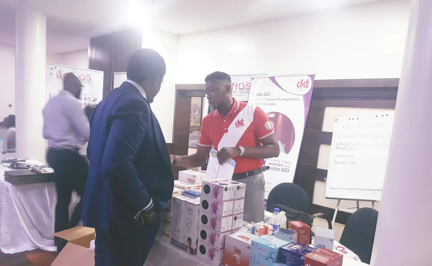 Public-health commodity demonstration with stakeholders around a display table